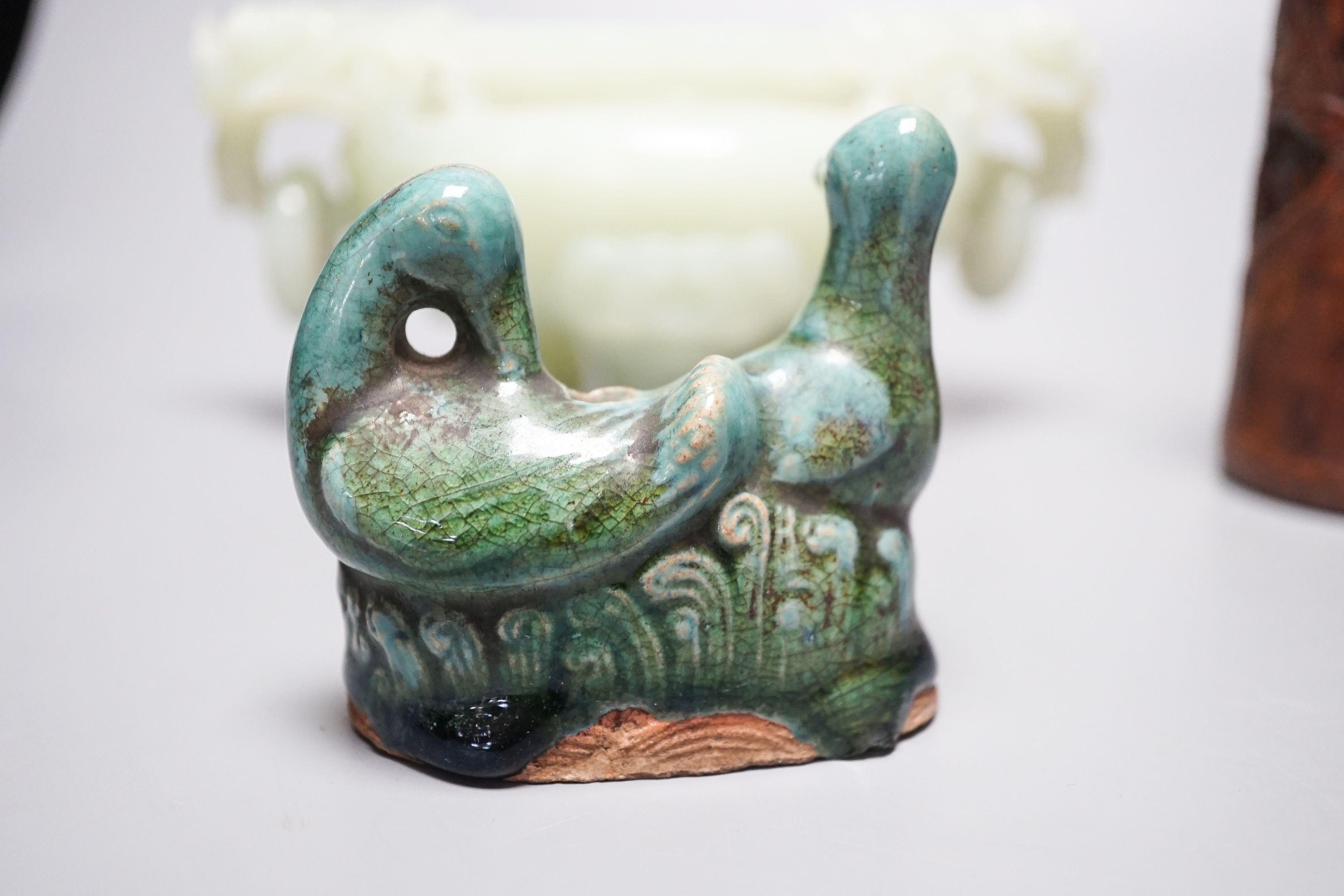 A Chinese bowenite jade tripod censer, 17cm wide, a Chinese green glazed ‘duck’ water dropper and a small bamboo brush part, 19th/20th century (3)